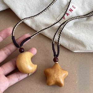 Handmade wooden moon and star pendant necklace with woven cord in bohemian style