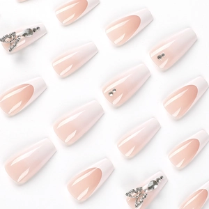 French tip press-on nails with 3D butterfly rhinestones and gradient nude pink base