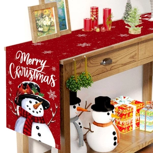 Christmas snowman table runner with Merry Christmas lettering on festive red fabric