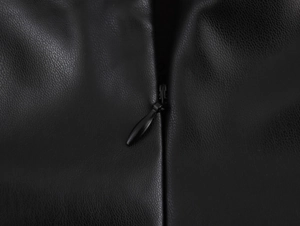 Close-up of black PU leather dress showing the high-quality invisible back zipper detail