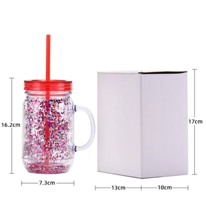 Transparent glitter plastic mason jar mug with red lid, straw and handle in studio shot