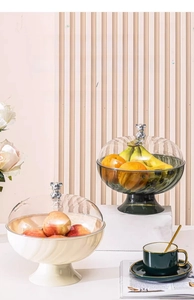 Close-up of luxury fruit tray with transparent lid and silver bear-shaped handle