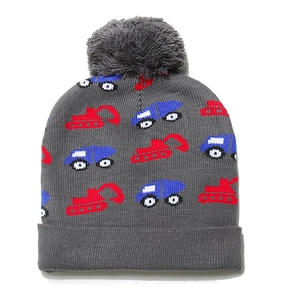 Detailed texture of kids knit beanie with excavator patterns and a soft pom-pom topper