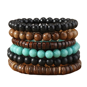 Macro shot of layered wooden and turquoise beads with natural textures on white background