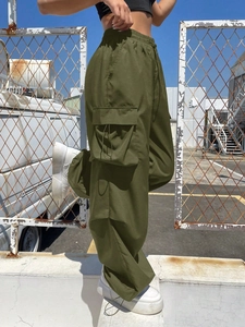 Detail of high waist army green cargo pants featuring functional large side pockets