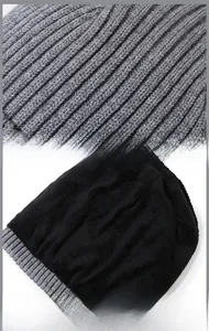 Detail view showing grey ribbed knit exterior and black thick fleece lining for winter warmth