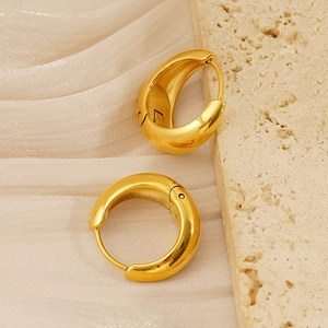 Close-up of chunky waterdrop earrings in 18k gold plated stainless steel on silk