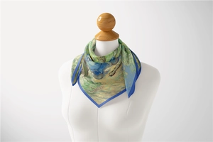 Silk scarf with Van Gogh Iris painting detail draped on a white mannequin