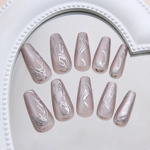 Silver 3D wave pattern cat-eye press-on nails in dusty pink ballet shape on mirror tray