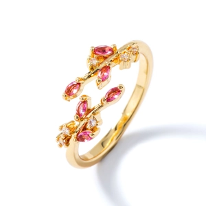 Elegant gold leaf ring with pink marquise and white round stones on white background