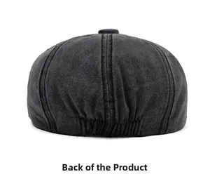 Back view of black washed cotton newsboy cap showing stitched panels and elastic band