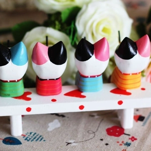 Nordic wooden fishing cat figurines set with four colorful striped cats on a white bench