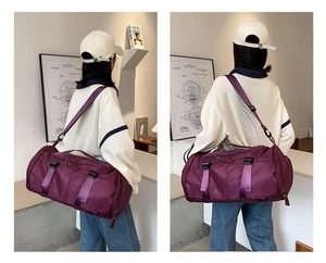 Detail of purple nylon travel bag with woven handles and black adjustable shoulder strap