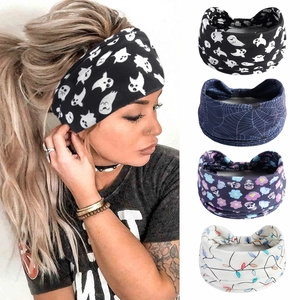 Detail view of wide Halloween headbands featuring ghost, spider web and skull patterns