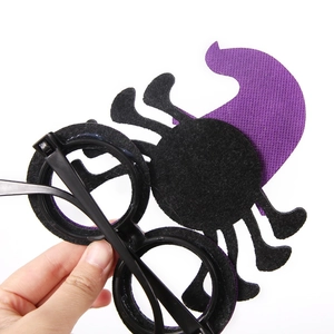 Halloween party glasses with purple witch hat and spider designs on black frame