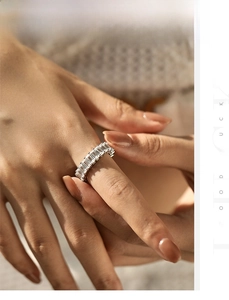 Close-up of S925 sterling silver baguette-cut sparkling crystal eternity ring on finger