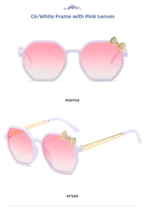 Close-up of kids octagonal white frame sunglasses with pink gradient lenses and gold bow