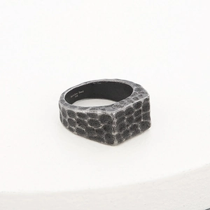 Macro detail of men's vintage hammer-textured 316L stainless steel wide band ring
