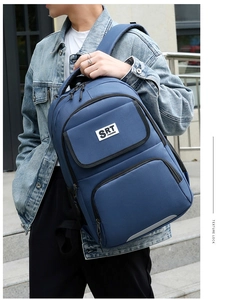 Blue business laptop backpack with fabric texture and reflective side stripes shown on model