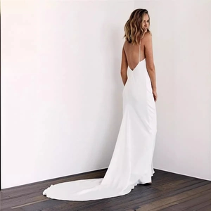 Elegant white satin mermaid bridal gown with backless straps and a long trailing train