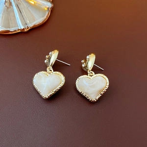 Detailed view of heart-shaped marble resin earrings with gold-toned crystal accents