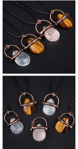 Detailed view of teardrop semi-precious stones wrapped in vintage copper wire