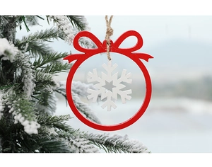 Detail of red wooden Christmas ornament with white snowflake cutout and a rustic jute string