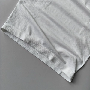 Close-up of white seamless yoga top featuring ribbed hem and jacquard texture detail