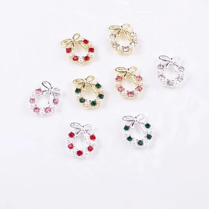 Detailed view of Christmas wreath nail charms with colorful rhinestones and pearls