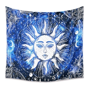 Detail of bohemian sun and moon tapestry with celestial star maps on dark blue fabric