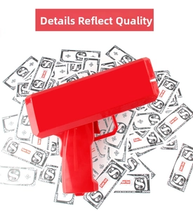 Detailed macro view of the bright red money gun toy with various simulation banknotes