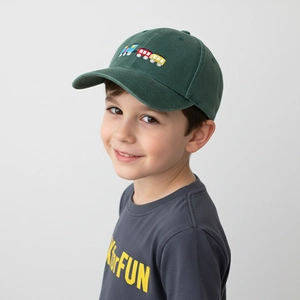 Detail of dark green cotton kid hat featuring colorful cartoon train embroidery