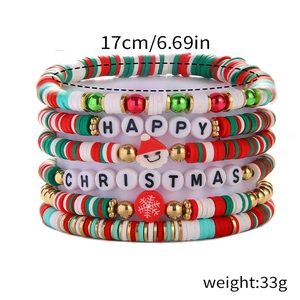 Macro detail of Christmas beaded bracelets with red, green, and white clay beads and charms