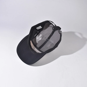Detail view showing interior label and adjustable strap of short brim baseball cap