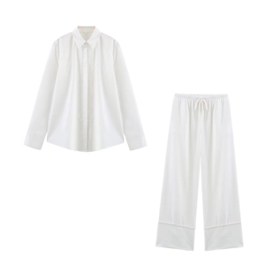 Women's white linen set featuring a long-sleeve shirt and wide-leg pants on white background