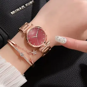 Rose gold watch with red dial paired with a delicate star charm rhinestone bracelet
