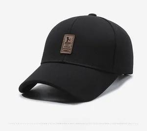 Detail of black baseball cap with leather patch featuring Ediko logo and mesh texture