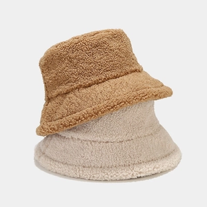 Thick warm lambswool bucket hat showing caramel and beige colors with curly texture
