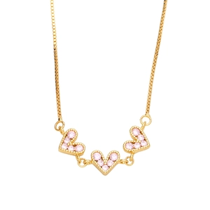 Elegant gold necklace with three pink cubic zirconia heart pendants on a box chain