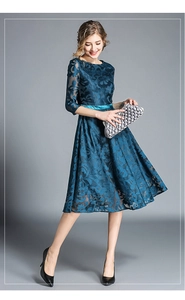 Detailed texture of dark blue floral lace fabric with an elegant satin waist belt