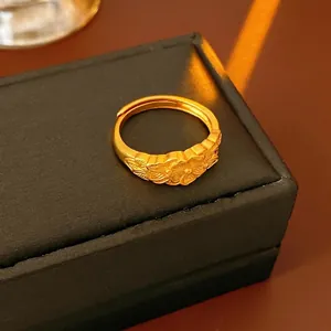 Vintage floral cross open ring in gold finish displayed on a black jewelry box