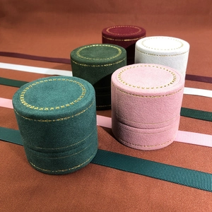 Elegant velvet round jewelry box with gold lace embroidery and ribbon accents