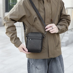 Black PU leather mini crossbody bag for men, featuring a matte finish and adjustable strap
