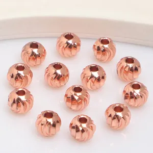 Detail of 14k gold plated textured beads with spiral cut patterns for DIY jewelry making