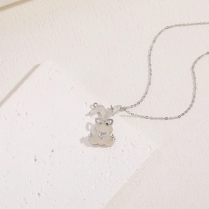 Detail of silver bunny pendant with white enamel heart and sparkling zircon stone