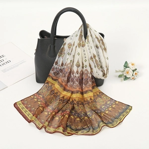 Detail of bohemian chiffon scarf with ethnic floral patterns draped on a handbag