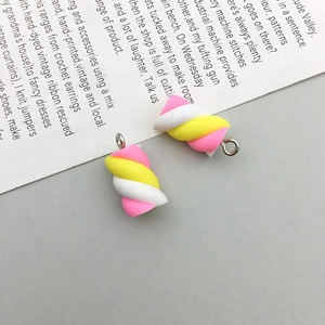 Close-up of pink and yellow resin marshmallow charms with metal rings for DIY jewelry making