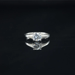 Elegant four-prong solitaire titanium steel ring with a brilliant round moissanite stone