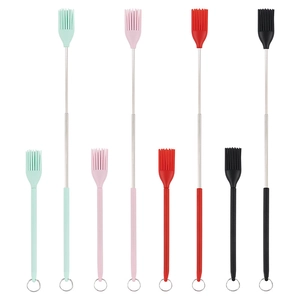 Mini silicone spatula set in four colors with retractable metal handles on white background