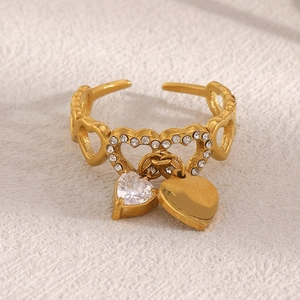 Detail of 18K gold plated heart tassel ring with sparkling rhinestone and hollow band